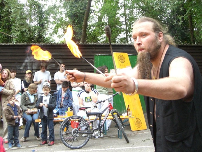 Gaukler zeigt eine Feuerkunst vor einem erwachsenen Publikum
